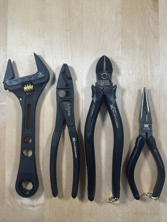 Set of Kurokin pliers and wrench on a wooden surface