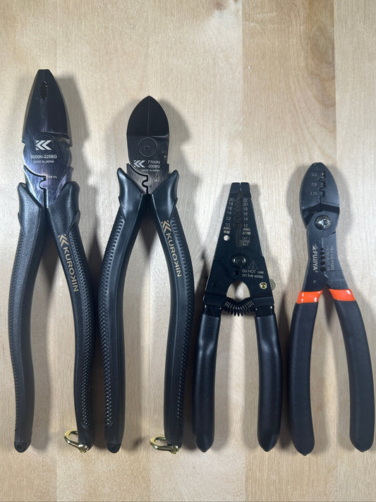 Set of pliers with 'Kuro' branding on a wooden surface